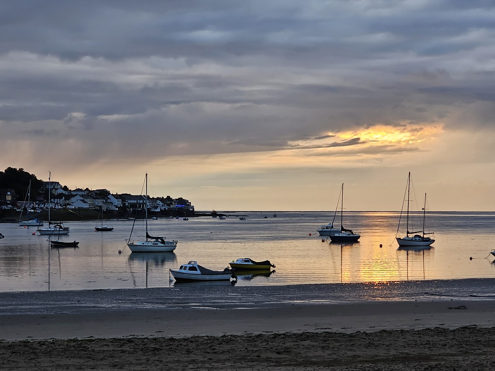 Boats moored on the estuary at sunset, with Instow and Appledore facing each other across the water