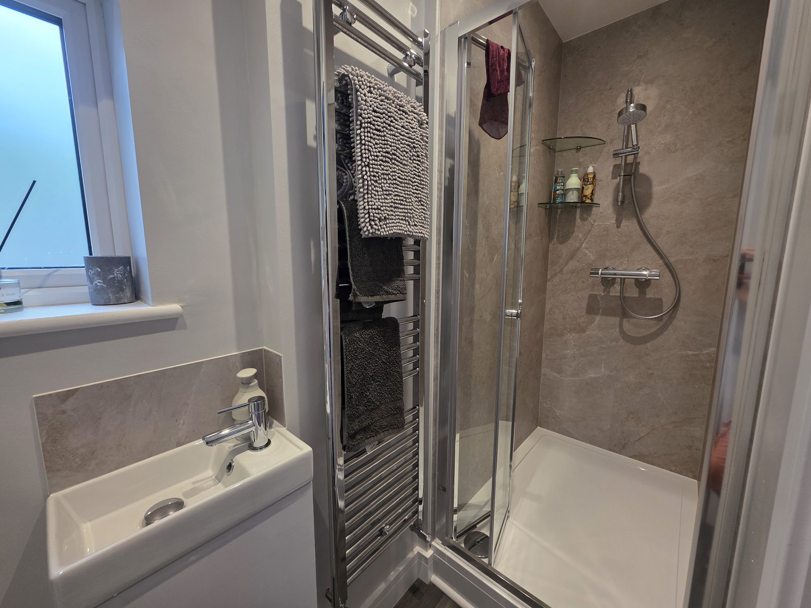 The en-suite shower room with a walk-in shower and basin